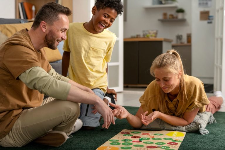 Familj med två barn spelar ett brädspel på vardagsrumsgolvet